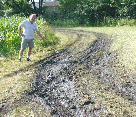 Don K9NR points out the muddy access road